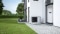 The picture shows a heat pump outside a house