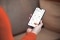The image shows a hand with a smartphone and the ViCare app open