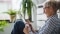 The image shows a woman with gray hair and tablet in her hands as a symbol for the control of Viessmann ViCare components via app.